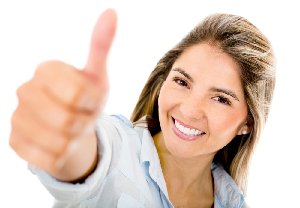 Happy woman with thumbs up - isolated over a white background
